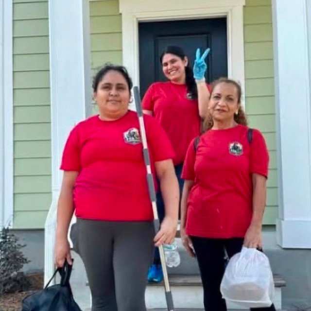 Three H&M Cleaning Lab team members with their equipment outside a client's home